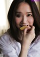 A woman is eating a piece of food. 