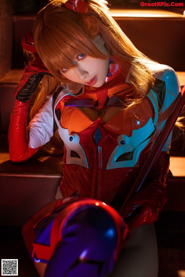 A woman in a red and blue outfit holding a sword.