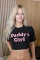 A woman in a black shirt that says Daddy's Girl.