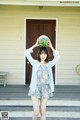 A woman holding a watermelon over her head.